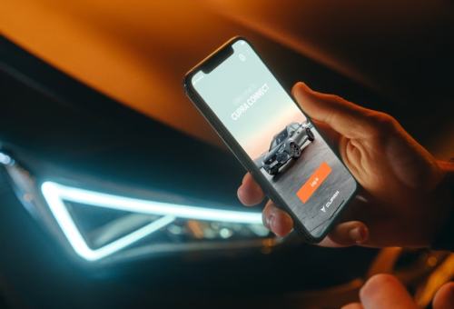 man-connected-to-cupra-connect-app-with-his-smartphone man-connected-to-cupra-connect-app-with-his-smartphone